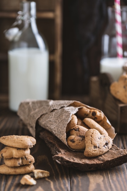 Biscuits au chocolat sur une table rustique en bois. Cookies aux pépites de chocolat en forme de coeur. Biscuits maison