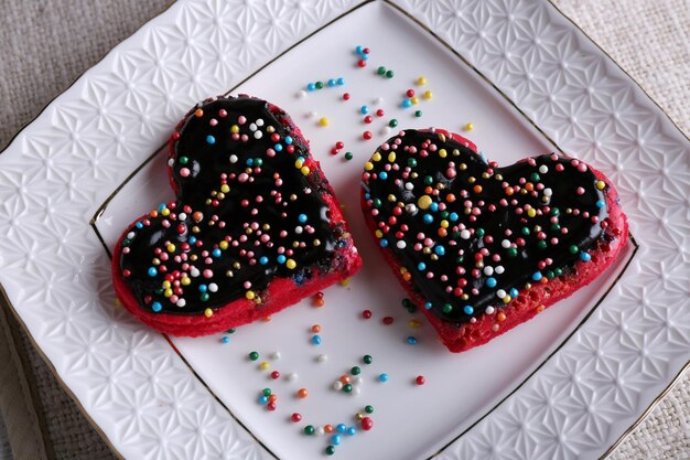 Biscuits en forme de coeur sur fond d'assiette et de serviette