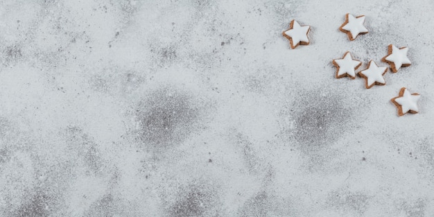 Biscuits en forme d'étoile sur fond blanc. Concept de vacances d'hiver. Vue de dessus, espace libre pour le texte