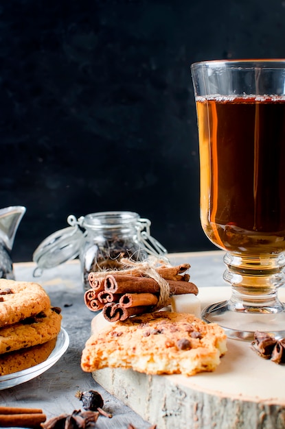 Biscuits avec des gouttes de chocolat, Ñ de thé, cannelle, anis sur fond sombre