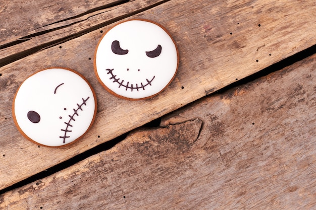 Biscuits Jack skellington sur fond de bois biscuits en pain d'épice ronds avec des visages d'halloween copie s...