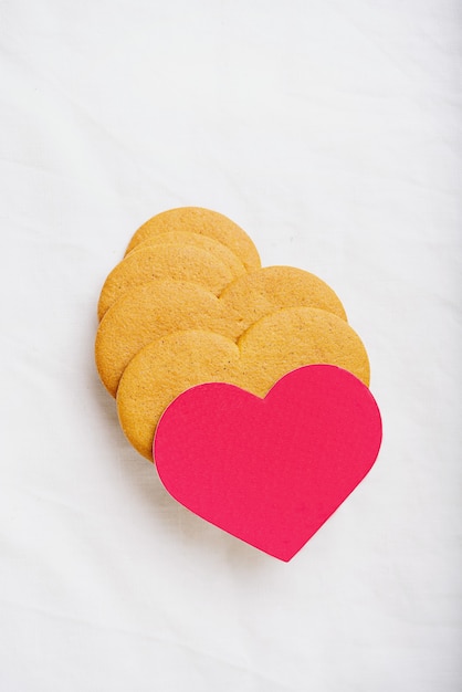 Biscuits en pain d'épice en forme de coeur avec carte rouge. Mise à plat. Vue de dessus