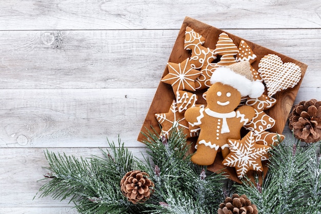 Biscuits de pain d'épice savoureux et décor de Noël sur fond en bois.