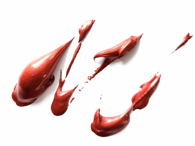 Blob de peinture acrylique rouge artiste sur un fond blanc.
