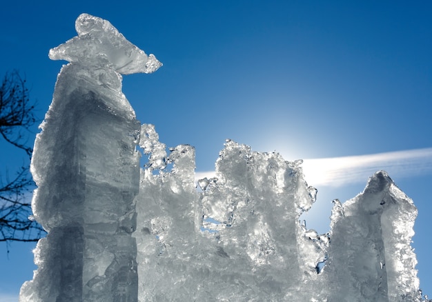 Bloc De Glace De Fonte Avec Soleil Derrière Sur Fond De Ciel Bleu.