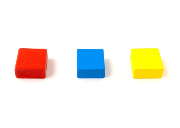 Blocs de bois jouet multicolore isolés sur fond blanc.