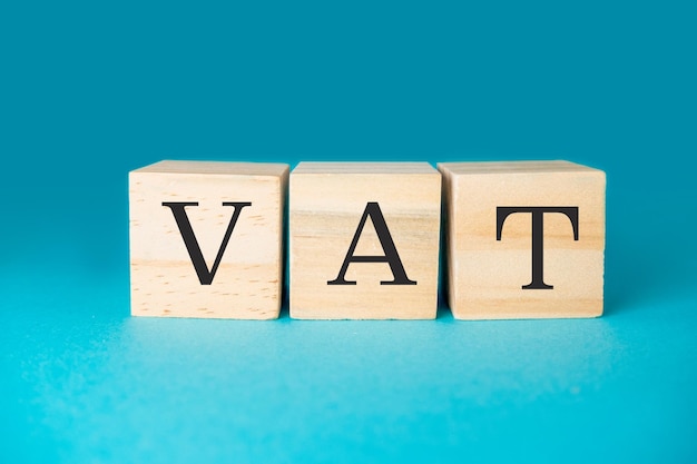 Des blocs de bois avec les lettres TVA sur un fond bleu gradient