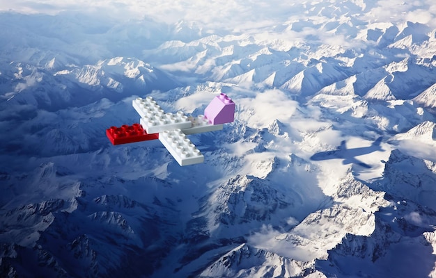 Blocs de construction en plastique avec vue d'angle supérieur de l'ombre de l'avion paysage de montagne de glace Concept créatif et idéal