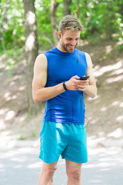 blog de remise en forme. entraînement. Application de remise en forme. Concept d'interface utilisateur ux. gadget dans le sport moderne. homme musclé en bracelet de remise en forme. application sportive sur téléphone. sport numérique. montre intelligente. homme athlétique heureux en vêtements de sport en ligne.