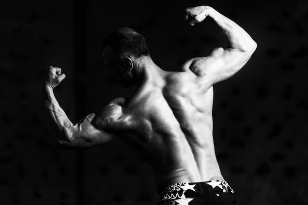 bodybuilder musclé montrant son dos double biceps