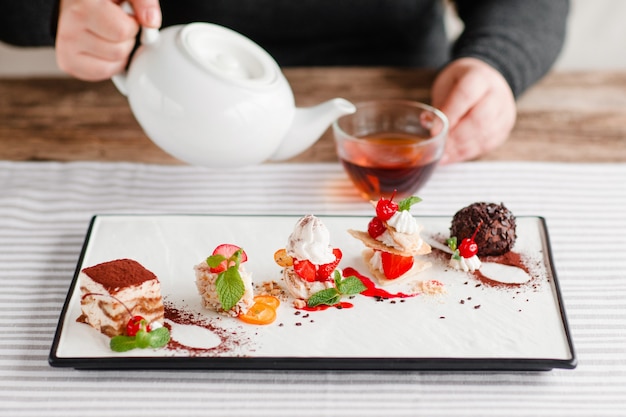 Boire le thé de l'après-midi avec des desserts sucrés