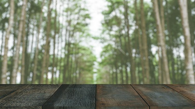 Bois de pin de la forêt verte floue avec premier plan de table en bois pour le montage de produits publicitaires