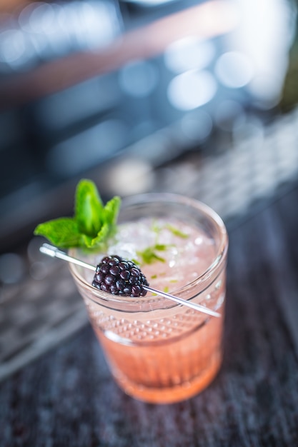 Boisson cocktail ronce aux baies noires et à la menthe au comptoir de la discothèque ou du restaurant.