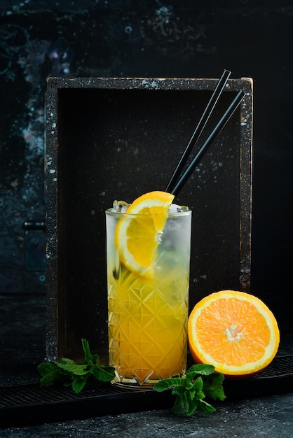 Une boisson rafraîchissante Limonade à l'orange avec de la glace et de la menthe dans un verre Menu du bar à cocktails