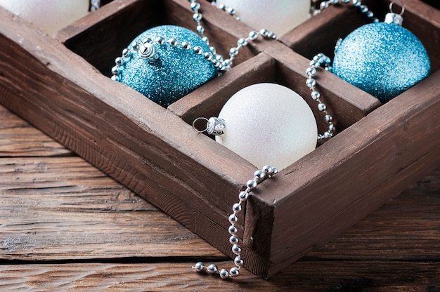Boîte avec des boules de Noël sur la table en bois