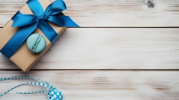 Une boîte-cadeau avec un ruban bleu et un arc bleu sur une table en bois