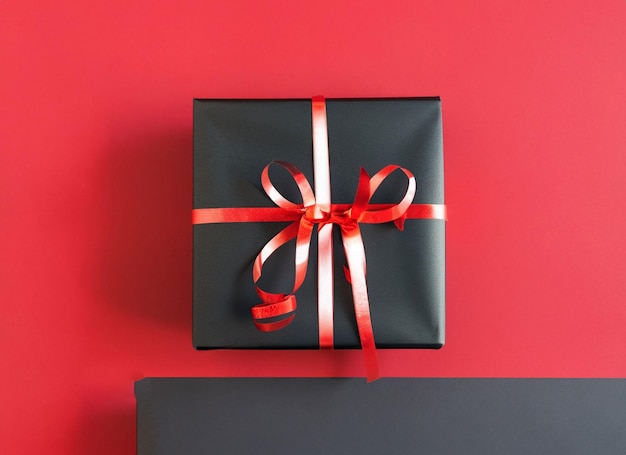 Boîte à cadeaux noire sur fond rouge et noir