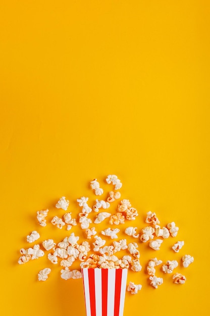 boîte en carton avec pop-corn sur fond jaune gros plan