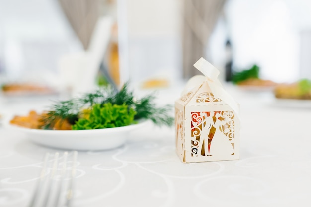 Boîte de papier beige bonbonniere au mariage est sur la table