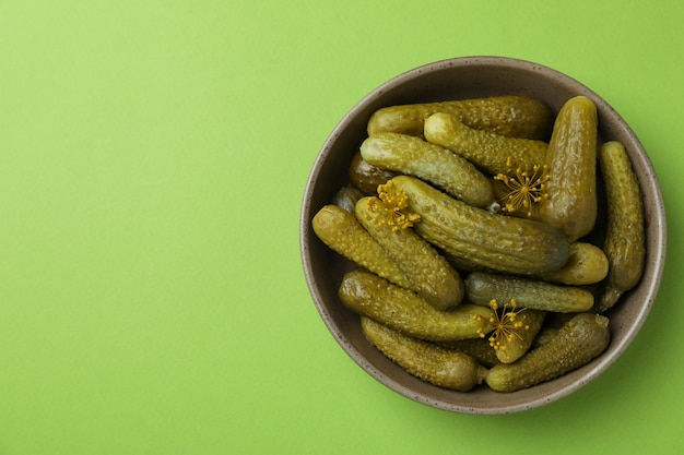 Bol de cornichons frais sur fond vert