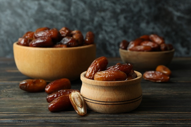 Bol avec dattes séchées sur table en bois