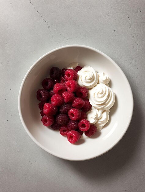 Photo un bol de framboises avec de la crème fouettée sur une table en béton