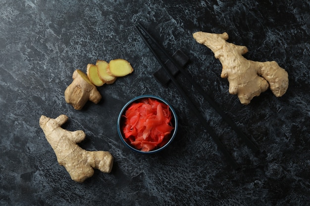 Bol avec gingembre mariné rouge et baguettes sur smokey noir