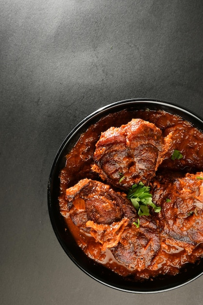 Un bol de nourriture avec une sauce rouge et un bol de sauce au curry.