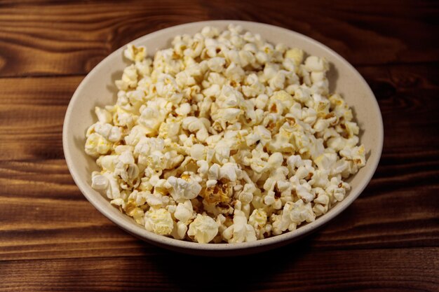 Bol avec pop-corn sur table en bois