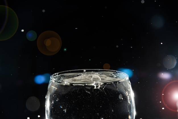 Photo un bol de verre transparent rempli d'eau avec des éclaboussures d'eau autour de lui effet éclabousse