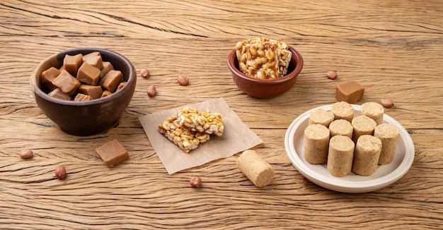 Bonbons brésiliens typiques sur table en bois Doce de leite ou dulce de leche pe de moleque et pacoca