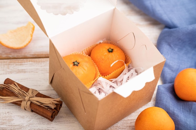 Photo bonbons à la mandarine au chocolat à la truffe sur un fond en bois blanc vue latérale mise au point sélective