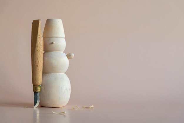 Bonhomme de neige avec un manche en bois et un manche en bois à côté.