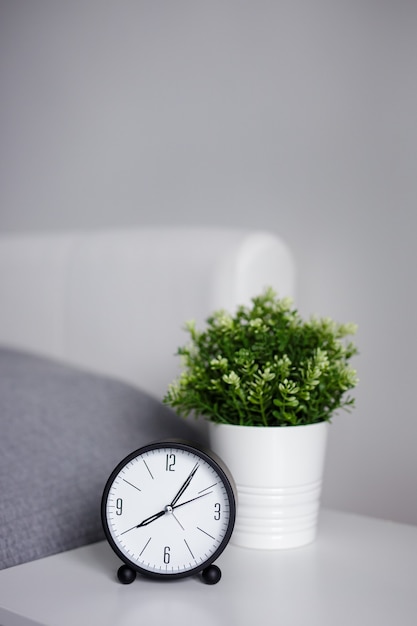 Bonjour concept - réveil sur table de chevet et espace de copie sur mur gris