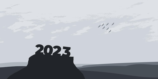 Bonne année 2023 avec de grandes lettres de silhouette sur la montagne avec un beau coucher de soleil