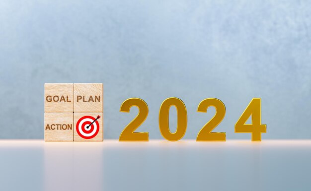 Photo bonne année 2024 avec une bannière d'or de concept d'entreprise numéro d'année 2024 et plan d'objectif cible action sur des cubes de bois planification des concepts d'objectif et de succès