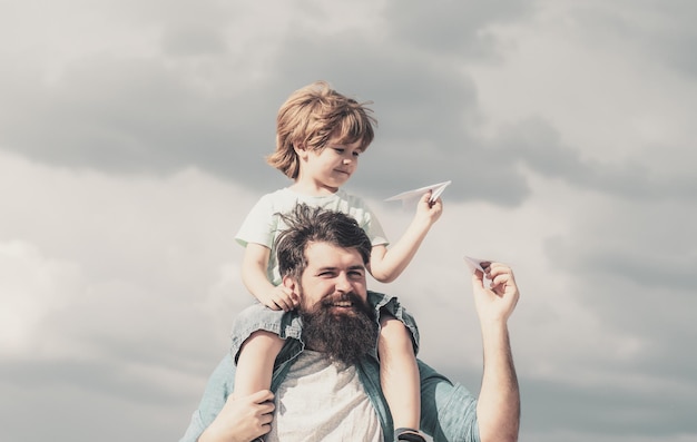 Bonne fête des pères papa et fils jouent sur fond de ciel père et fils dans le parc liberté de dr