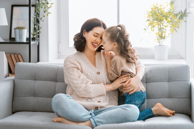 Bonne journée maman et sa fille enfant fille jouent en souriant et en serrant