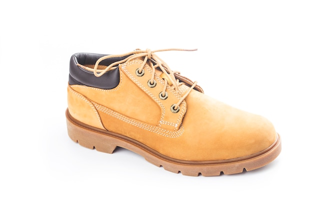 Bottes pour hommes en cuir nubuck jaune sur mur blanc