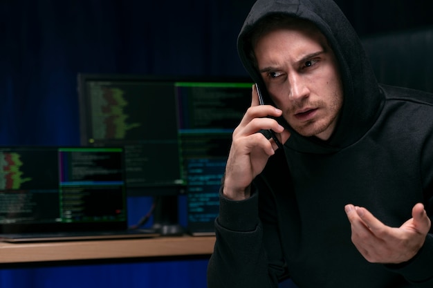 Photo bouchent hacker parlant au téléphone