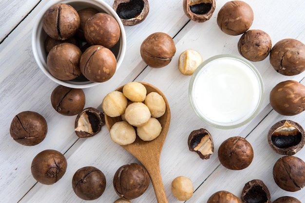 Bouchent le lait de noix de macadamia sur une table en bois, boisson saine faible en gras.