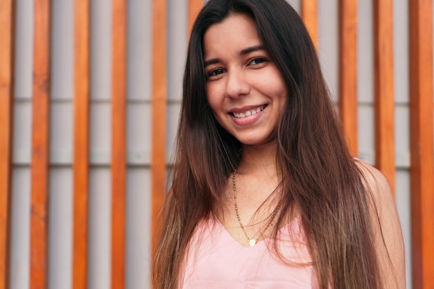 Bouchent le portrait d'une belle jeune latina souriante et regardant la caméra.