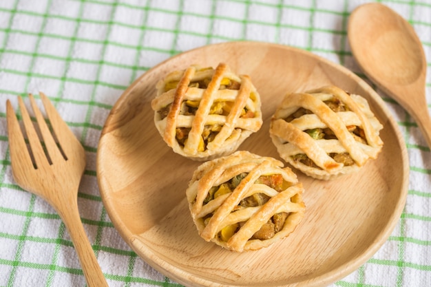 Bouchent tarte au poulet sur un plat en bois