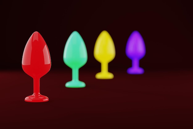 Bouchons anaux Jouets pour adultes Différentes couleurs rougeoyantes sur fond sombre Sex shop concept de divertissement intime rendu 3D