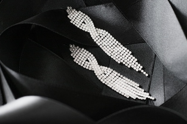 Boucles d'oreilles en diamant de luxe sur ruban de soie noire comme bijoux de fond et marque de mode