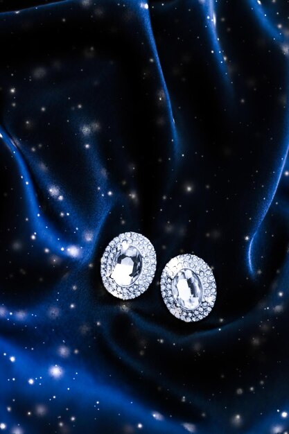 Boucles d'oreilles en diamant de luxe sur soie bleu foncé avec des bijoux magiques d'hiver de vacances de paillettes de neige présents