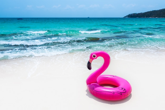 Bouée de sauvetage en caoutchouc rose sur la plage.