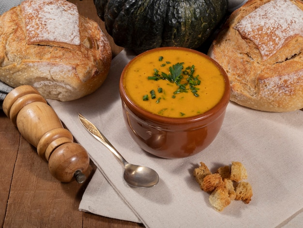 Bouillon de potiron sur fond en bois.