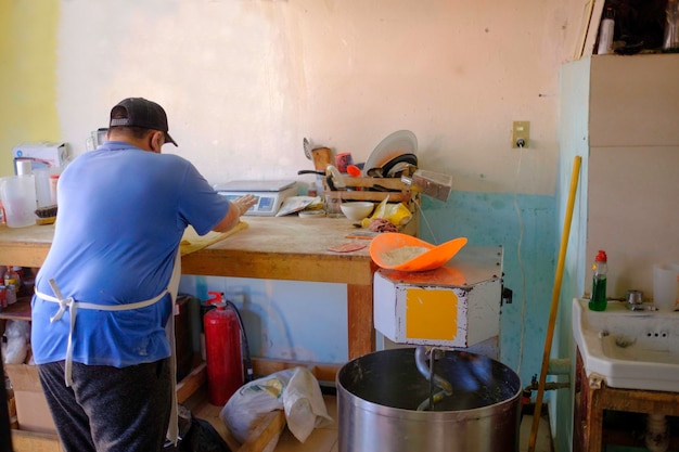 Boulanger latin avec masque travaillant dans une boulangerie et pâtisserie traditionnelle mexicaine.