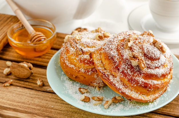 Boulangerie suédoise traditionnelle ou kanelbulle aux noix sur un plateau en bois. Concept de petit déjeuner ou de collation. Fermer